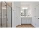 Main bathroom featuring a glass enclosed shower, double sink vanity, and herringbone tile floors at 490 Boulder Point Dr, Chapel Hill, NC 27516