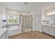 Main bathroom features a separate shower and tub, double vanity, tile floors, and lots of natural light at 490 Boulder Point Dr, Chapel Hill, NC 27516