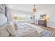 Bright main bedroom features wood floors, lots of windows, neutral paint, and a chandelier at 490 Boulder Point Dr, Chapel Hill, NC 27516
