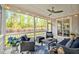 Comfortable screened porch with outdoor furniture, ceiling fan, and view of the backyard at 490 Boulder Point Dr, Chapel Hill, NC 27516