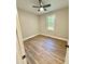 Bedroom featuring wood-look floors, window, and ceiling fan at 50 Lakewood Dr, Roxboro, NC 27573