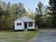 New construction home showcasing a well-manicured lawn and a bright exterior with white siding and black accents at 50 Lakewood Dr, Roxboro, NC 27573