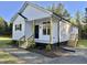 Charming single Gathering home featuring board and batten siding and a welcoming front porch at 50 Lakewood Dr, Roxboro, NC 27573