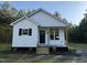 Charming new construction home featuring white siding, black shutters, and a welcoming front porch with natural wood accents at 50 Lakewood Dr, Roxboro, NC 27573