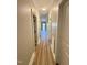 Hallway with wood-look floors and white doors at 50 Lakewood Dr, Roxboro, NC 27573