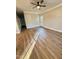 A spacious living room featuring natural light, modern hardwood flooring, and a ceiling fan at 50 Lakewood Dr, Roxboro, NC 27573