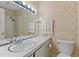 Bathroom featuring wallpaper, lights, mirrors, sink, and toilet at 505 Forest Rd, Oxford, NC 27565