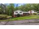 Charming brick and vinyl two-story home with a well-maintained front yard and lush landscaping at 505 Forest Rd, Oxford, NC 27565
