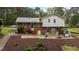 View of backyard with brick and vinyl siding, concrete patio, privacy features and mature trees at 505 Forest Road Rd, Oxford, NC 27565