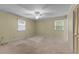 A bright bedroom featuring neutral walls, carpeted flooring, and a ceiling fan at 505 Forest Road Rd, Oxford, NC 27565