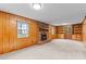 Spacious living room with wood paneling, a brick fireplace, and built-in shelving at 505 Forest Road Rd, Oxford, NC 27565
