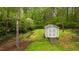Exterior view of a storage shed with double doors and a ramp, nestled in a wooded area at 505 Forest Road Rd, Oxford, NC 27565