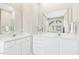 Bathroom featuring dual vanities with white cabinets, large mirrors, and ample counter space at 507 Presque Isle Ln # Bldg 500, Chapel Hill, NC 27514