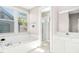 Bright bathroom featuring a soaking tub, tiled walls, and separate walk-in shower at 507 Presque Isle Ln # Bldg 500, Chapel Hill, NC 27514