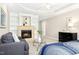 Comfortable bedroom with a fireplace, built-in shelves, seating area and a blue patterned bedspread at 507 Presque Isle Ln # Bldg 500, Chapel Hill, NC 27514