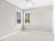 Bright bedroom featuring two windows, neutral walls, trim and carpet with base molding at 507 Presque Isle Ln # Bldg 500, Chapel Hill, NC 27514