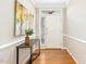 Bright entryway with hardwood floors, white trim, and a stylish console table with contemporary art at 507 Presque Isle Ln # Bldg 500, Chapel Hill, NC 27514