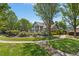 Beautiful community building exterior with lush landscaping, a manicured lawn, and inviting sidewalk at 507 Presque Isle Ln # Bldg 500, Chapel Hill, NC 27514