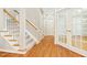 A freshly painted hallway showcases hardwood floors, a staircase, and multiple doorways at 507 Presque Isle Ln # Bldg 500, Chapel Hill, NC 27514