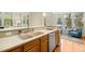A bright kitchen featuring ample counter space, a stainless steel dishwasher, and a view into the living area at 507 Presque Isle Ln # Bldg 500, Chapel Hill, NC 27514