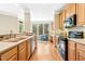 Well-lit kitchen with stainless steel appliances, wooden cabinets, and a view into the living room at 507 Presque Isle Ln # Bldg 500, Chapel Hill, NC 27514