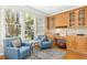 A bright living space with natural light features built-in cabinets, a desk area, and stylish blue armchairs at 507 Presque Isle Ln # Bldg 500, Chapel Hill, NC 27514