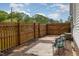 Private backyard with a wooden fence, patio furniture, and space for outdoor activities at 509 N Elm St, Benson, NC 27504