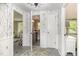 Hallway leading to bathroom with stylish wallpaper and access to other areas of the home at 509 N Elm St, Benson, NC 27504