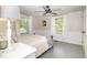 Cozy bedroom featuring two windows, a ceiling fan and neutral decor, providing a relaxing atmosphere at 509 N Elm St, Benson, NC 27504