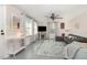 Bright living room with large windows, ceiling fan, and cozy seating area with a sectional sofa at 509 N Elm St, Benson, NC 27504