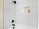 Modern bathroom features white subway tile, matte black fixtures, and a recessed niche at 513 Hugo St, Durham, NC 27704