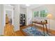 Well-lit home office featuring hardwood floors, a wooden desk, a blue area rug and a large window at 513 Hugo St, Durham, NC 27704