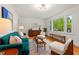 Bright living room with hardwood floors, stylish furniture, and a large window offering a view of the outdoors at 513 Hugo St, Durham, NC 27704