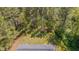 Aerial view of the property showcasing backyard, shed, home exterior, deck, and surrounding lush greenery at 5604 Bobcat Rd, Chapel Hill, NC 27516