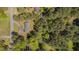 Overhead view of house surrounded by lush greenery and trees, highlighting its private and natural setting at 5604 Bobcat Rd, Chapel Hill, NC 27516