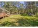 Well-maintained backyard with lush lawn, mature trees, shed, and partial view of the house at 5604 Bobcat Rd, Chapel Hill, NC 27516