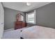 Bedroom with gray walls, carpet, dresser, and a window with natural light at 5604 Bobcat Rd, Chapel Hill, NC 27516