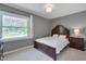 Bedroom with gray walls, carpet, wood bed frame, and a window with a view to the exterior at 5604 Bobcat Rd, Chapel Hill, NC 27516