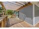 Covered wooden deck with gray siding, sliding glass door, and railings, offering outdoor living space at 5604 Bobcat Rd, Chapel Hill, NC 27516