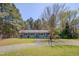 Charming single story home with beautiful lawn and mature tree, with gravel drive, creating a welcoming curb appeal at 5604 Bobcat Rd, Chapel Hill, NC 27516