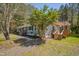 Charming home with a light blue exterior, a pergola deck, and a gravel driveway at 5604 Bobcat Rd, Chapel Hill, NC 27516