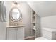 Powder room featuring an oval mirror, storage shelves, and neutral paint color at 601 E Dynasty Dr, Cary, NC 27513