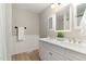Bathroom featuring dual sinks, ample lighting, a mirror, and wainscotting at 601 E Dynasty Dr, Cary, NC 27513