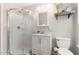 Bathroom featuring a glass enclosed shower and white vanity with ample storage at 601 E Dynasty Dr, Cary, NC 27513