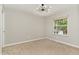 Bedroom featuring neutral walls and carpet, bright window, and modern ceiling light at 601 E Dynasty Dr, Cary, NC 27513