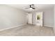 Spacious bedroom with neutral carpet, ceiling fan, two doorways, and natural light at 601 E Dynasty Dr, Cary, NC 27513