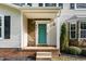 Close up of the front door with stone detail and a bright teal color that pops at 601 E Dynasty Dr, Cary, NC 27513