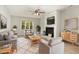 Bright living room with white painted stone fireplace, ceiling fan, and cozy seating area at 601 E Dynasty Dr, Cary, NC 27513