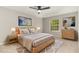 Bright primary bedroom with natural wood furniture, neutral walls, ceiling fan, and natural light at 601 E Dynasty Dr, Cary, NC 27513