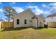 Spacious backyard with new wooden fence, green lawn, and convenient access door at 617 Ray St, Selma, NC 27576